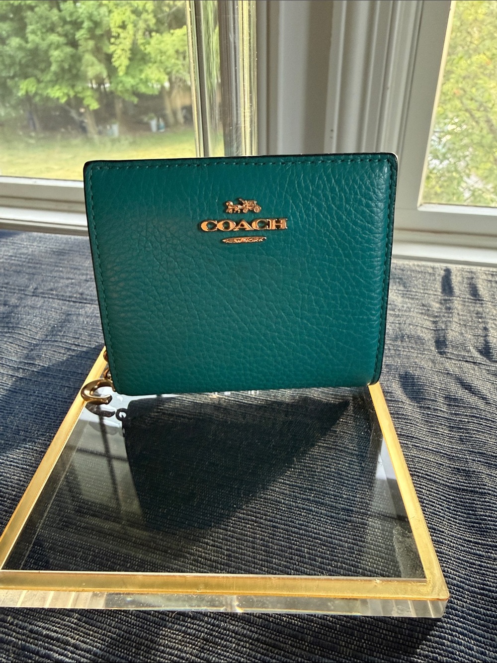 Coach dark teal snap wallet with Signature C charm zipper pull